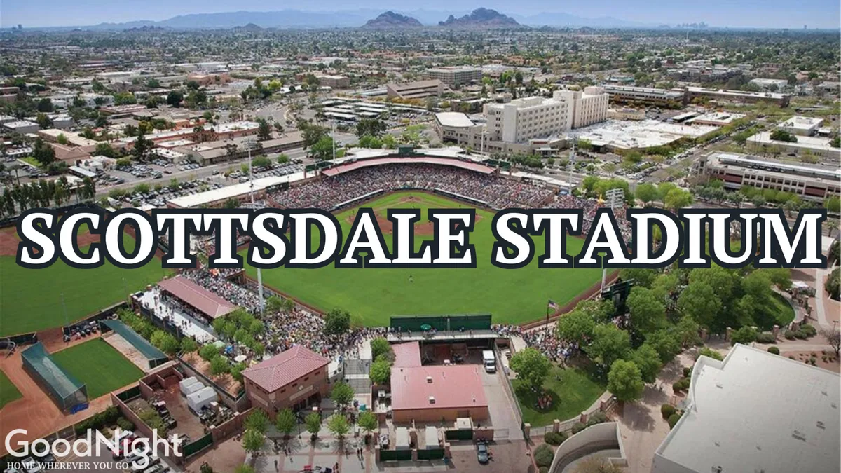 A wide shot of Scottsdale Stadium filled with spectators, a lush green baseball field, and the surrounding cityscape. The mood is communal and lively, perfect for illustrating group outings to spring training baseball games.